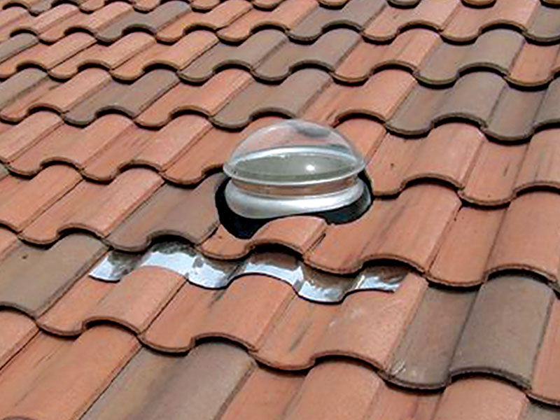 Kennedy tubular skylight installed on tile roof with tile skirt